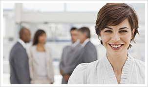 Businesswoman with peers behind