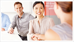 Female professionals shaking hands